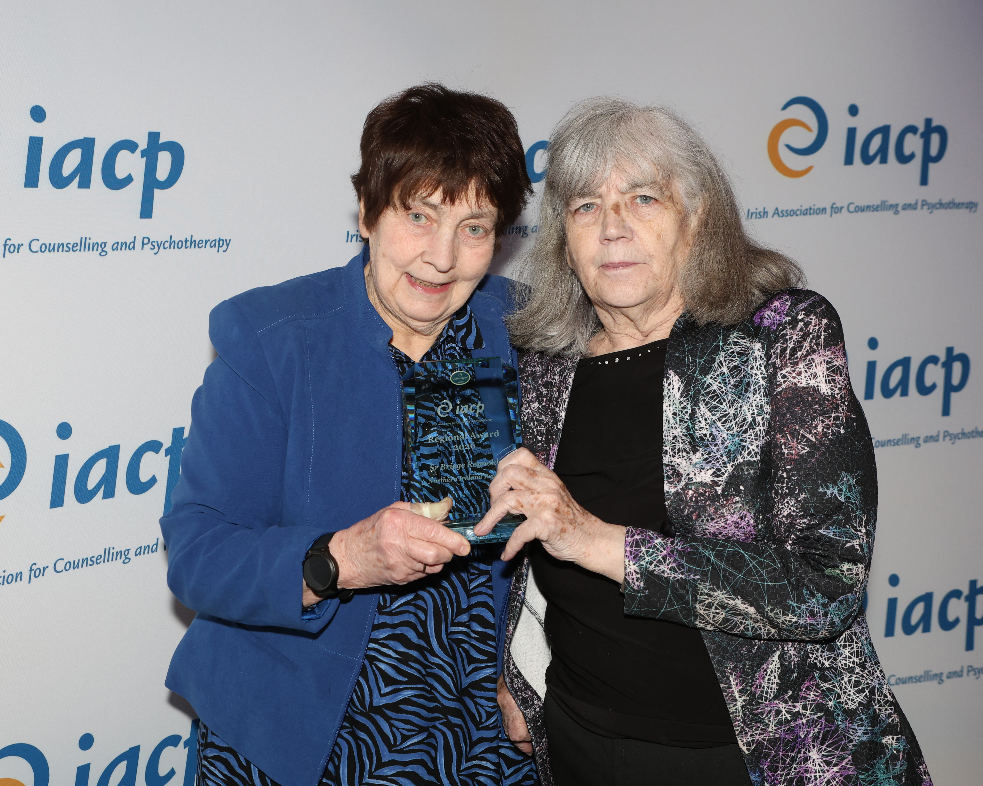 Rose Reynolds and Mary Corcoran accept the Northern Ireland Regional Award on behalf of their late sister Briege Reynolds